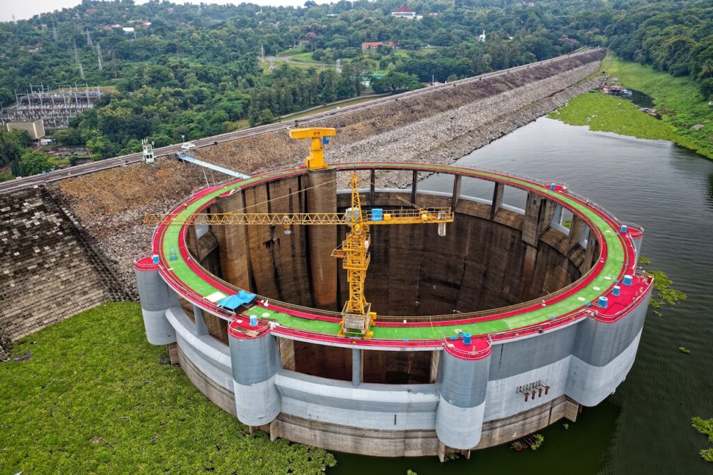 Aerial shot of Jatiluhur Dam construction site amidst lush greenery in West Java, Indonesia.